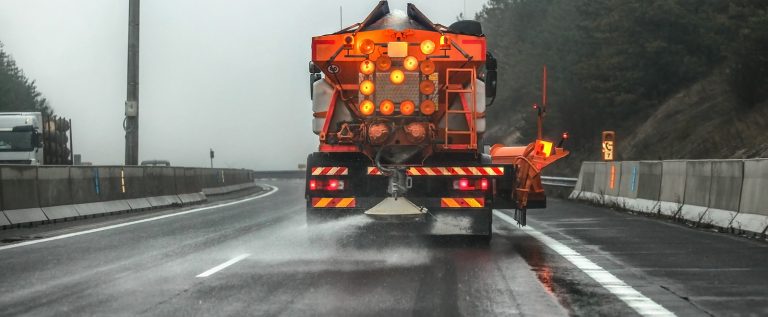 Orange Highway Maintenance Gritter Truck Spreading De-icing Salt